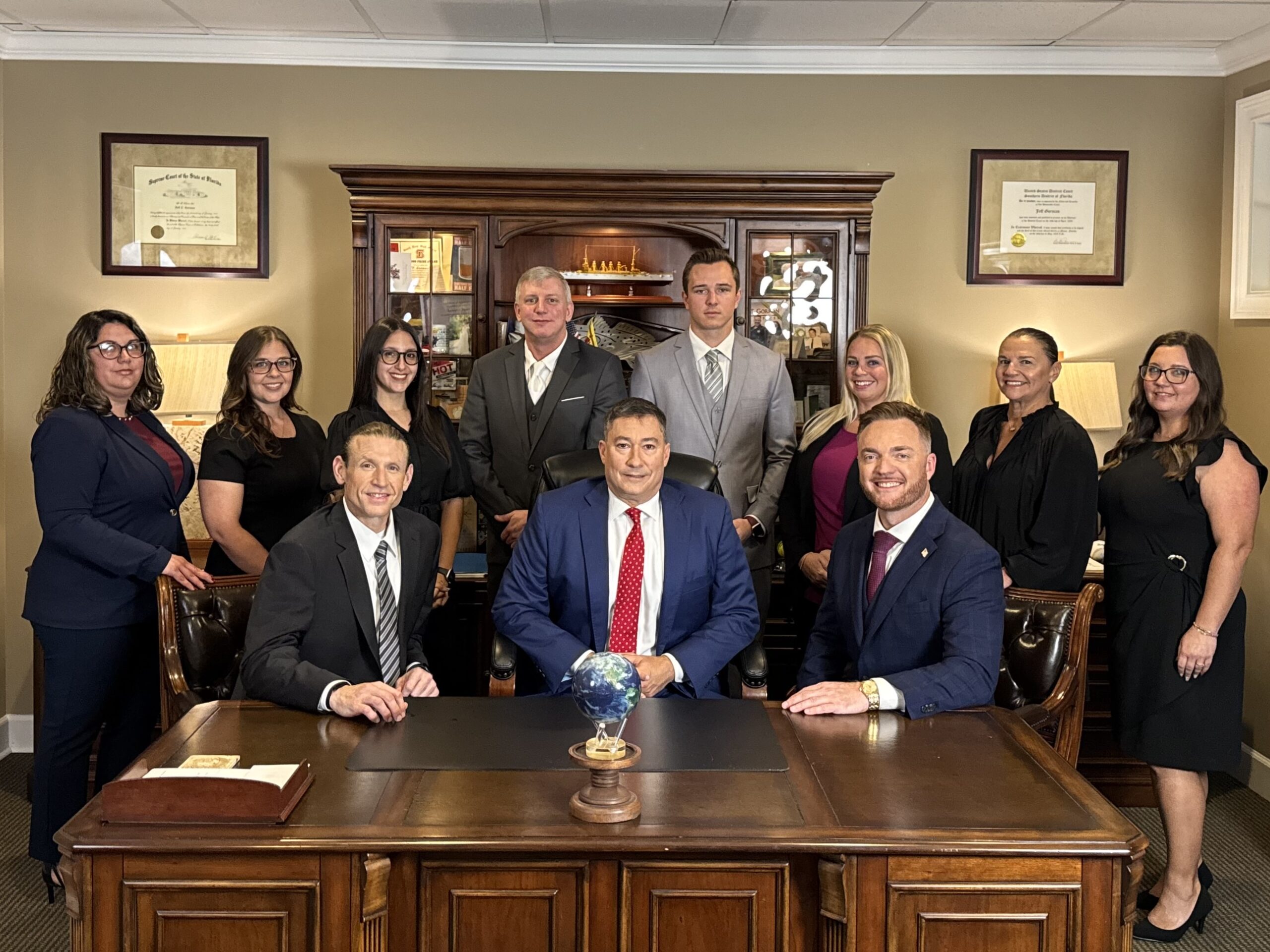 Jeff Gorman Law Offices team discussing auto accident claims and victim rights in Stuart, Florida.