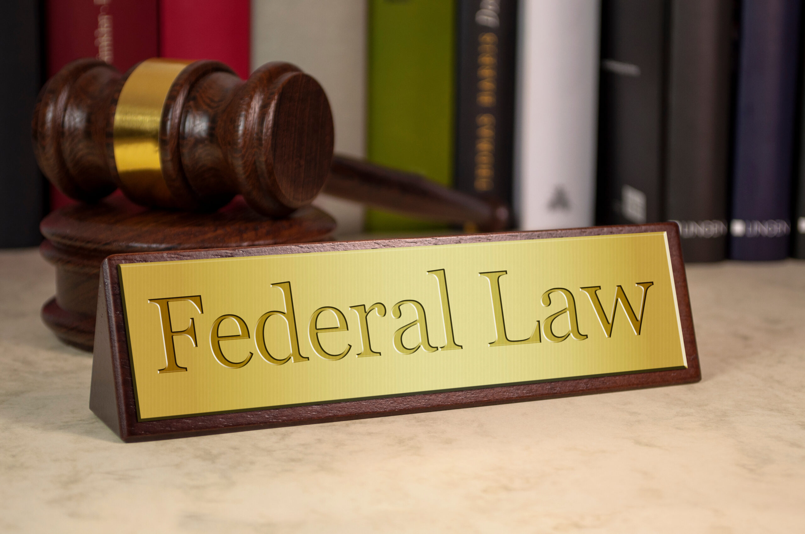 Desk nameplate displaying the words “Federal Law,” symbolizing federal legal authority and jurisdiction