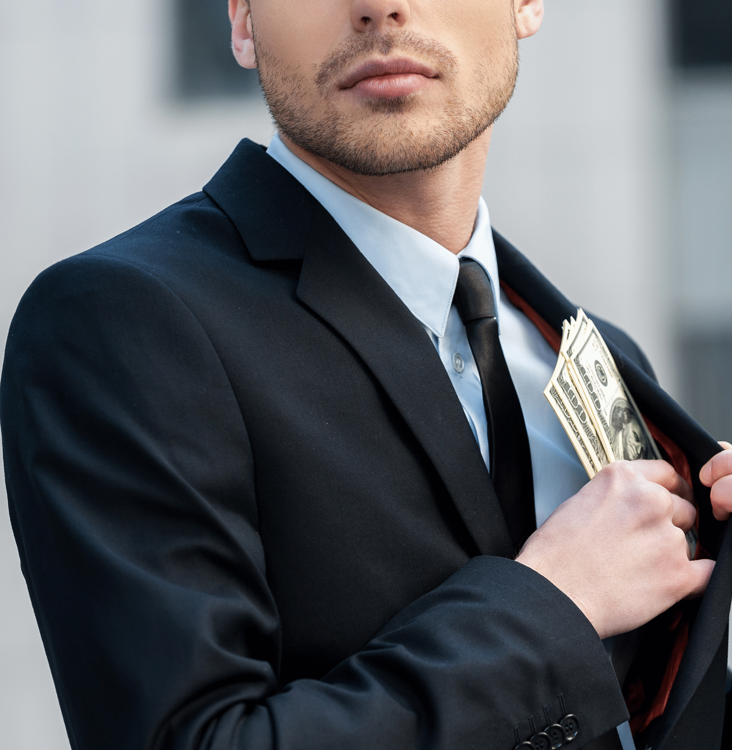 Hands counting large stacks of cash at a desk, suggesting financial misconduct or embezzlement