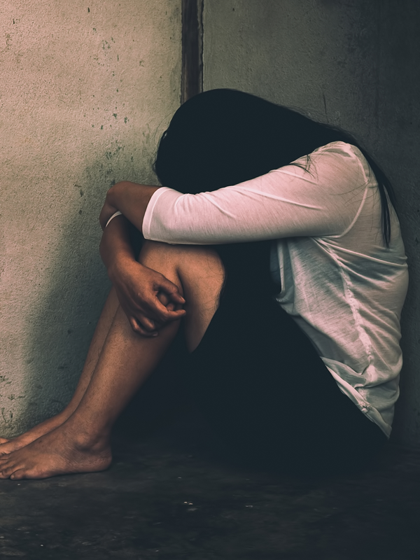 Silhouetted figure sitting in distress, symbolizing the seriousness of a sexual assault allegation