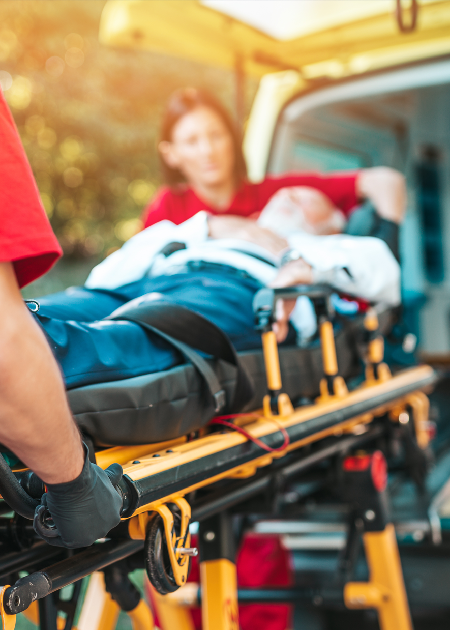 Injured person being placed into an ambulance after a serious auto accident