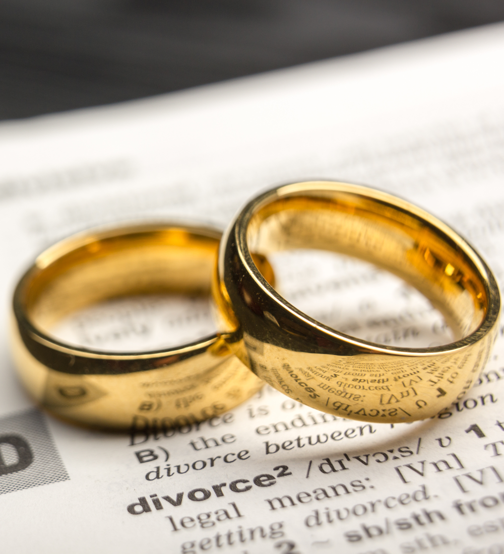 Two people peacefully signing documents together, symbolizing a collaborative divorce agreement