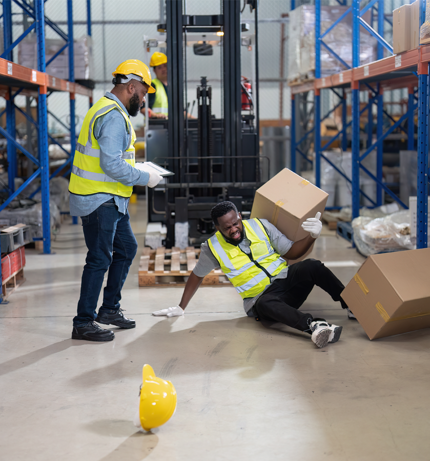 Industrial worker in a hard hat documenting details after a workplace injury