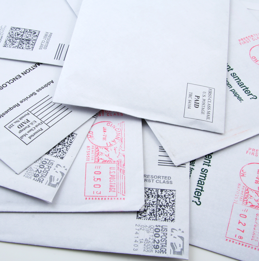 U.S. mailbox with outgoing envelopes, symbolizing criminal charges related to mail fraud
